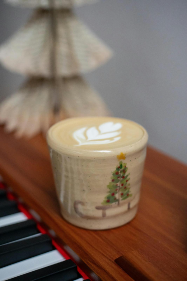 Image of a latte in a Christmas tree cup
